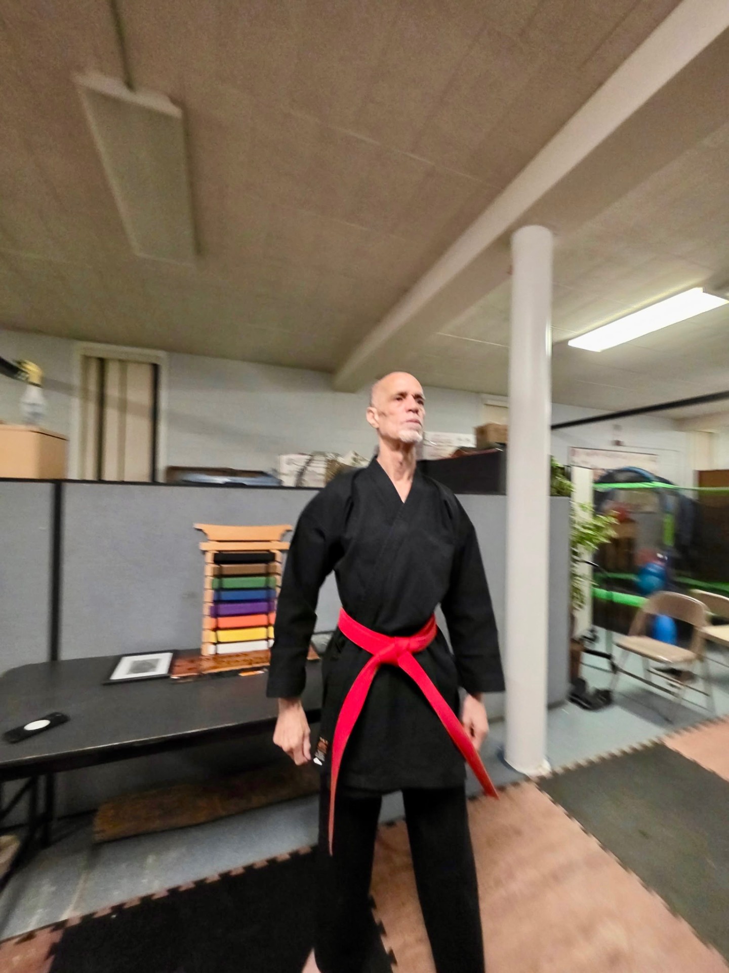 Sensei Kassama in black gi with red belt