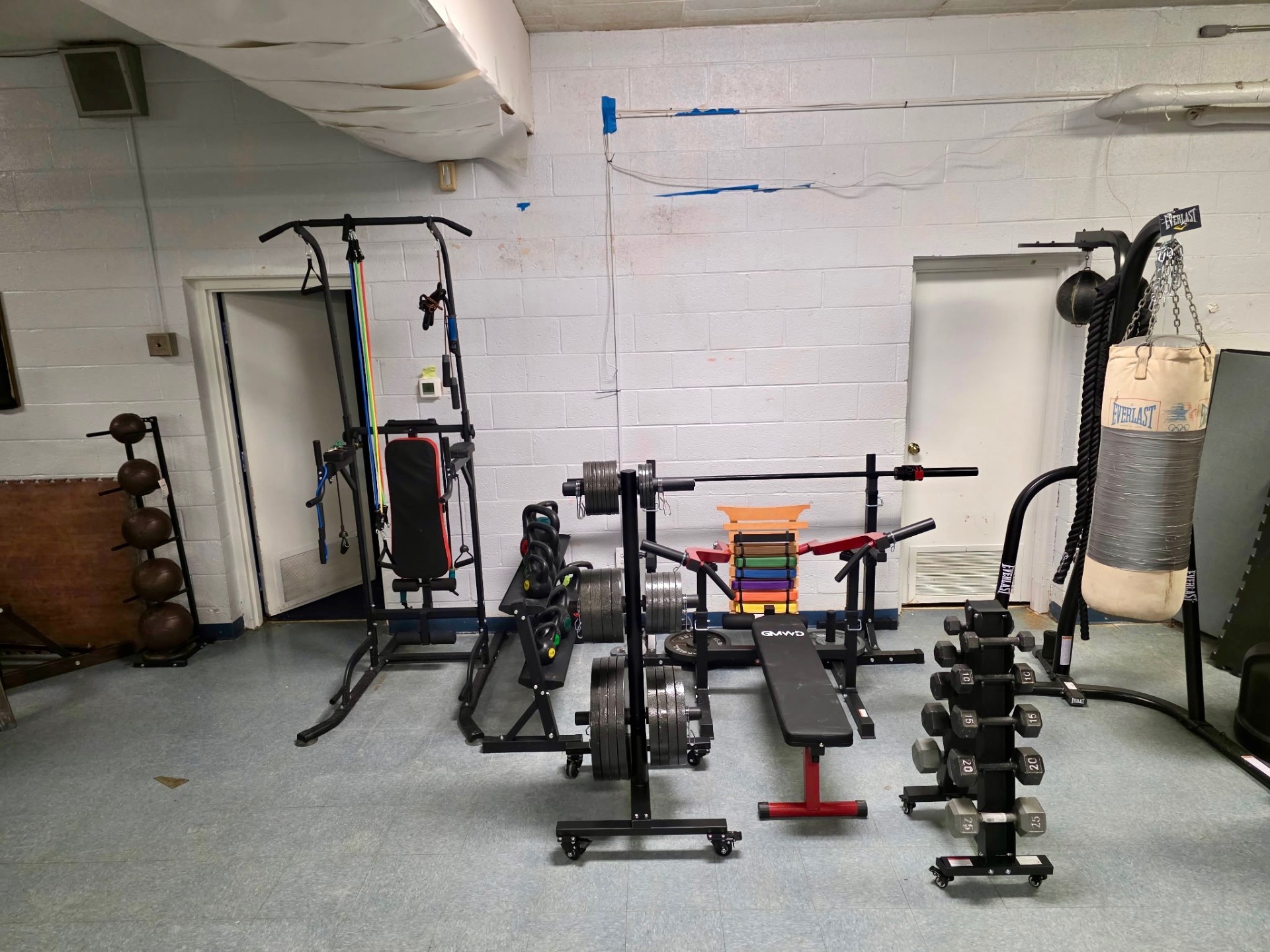 Strength corner with cable machine, kettlebells, and barbell
